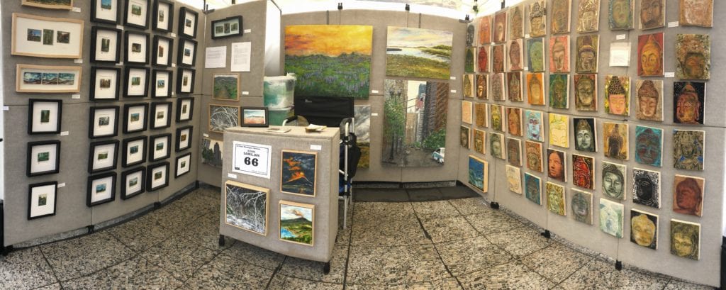 A group of paintings on display in an art gallery.