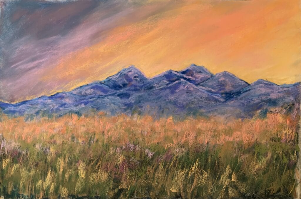 Colorful landscape with mountains and grassy field.