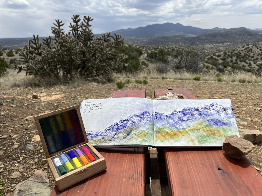 A table with an open book and some paint