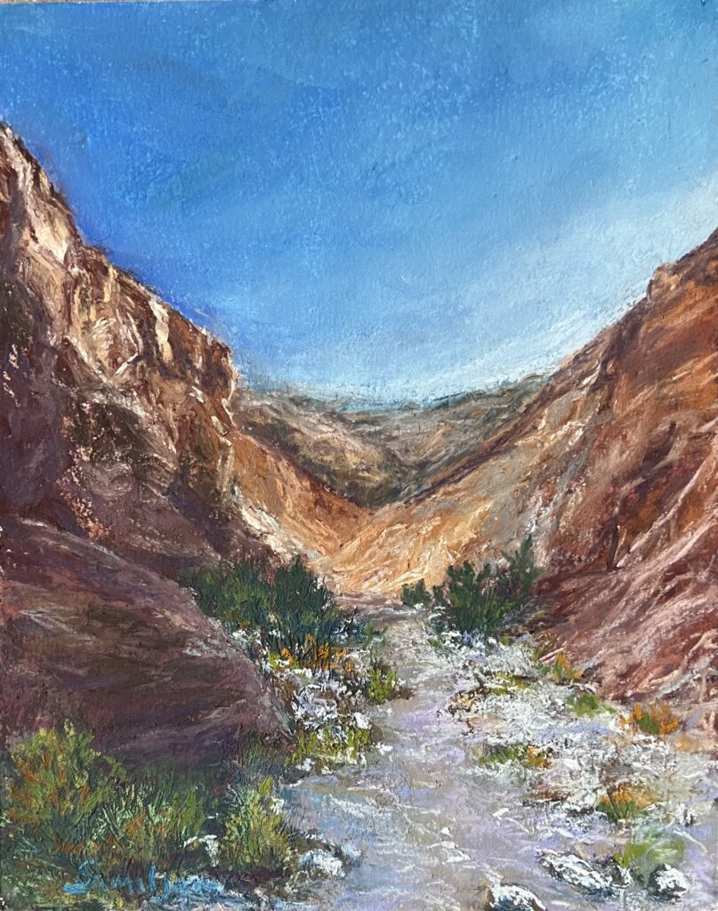 Canyon landscape with blue sky and rocks.