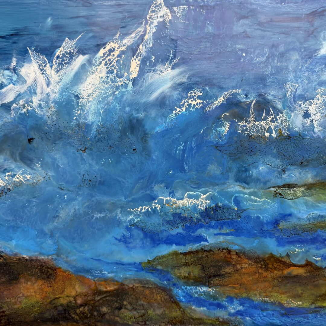 Abstract blue ocean waves crashing over rocky shore