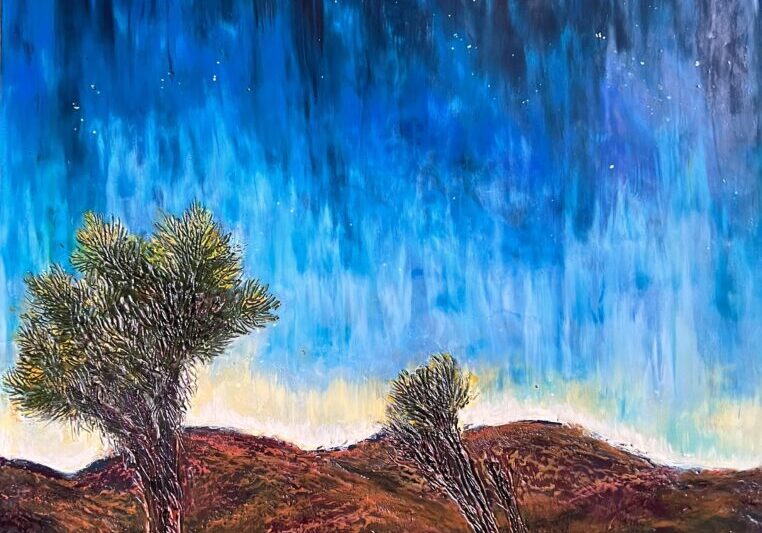 Starry desert landscape with two trees.