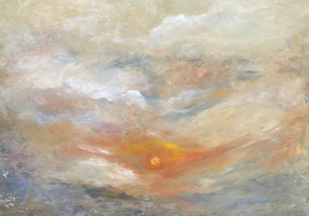 Pastel sunrise with sun peeking through clouds